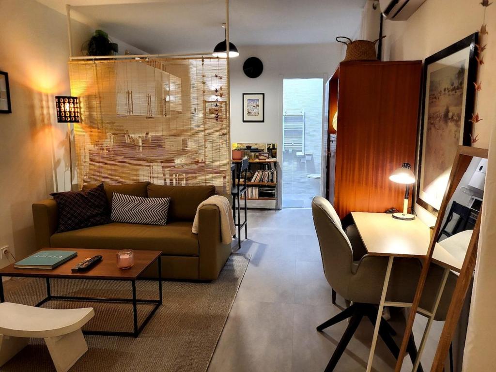 un salon avec un canapé et une table dans l'établissement Appartement de 30m2 agréable et chaleureux, à Pérols