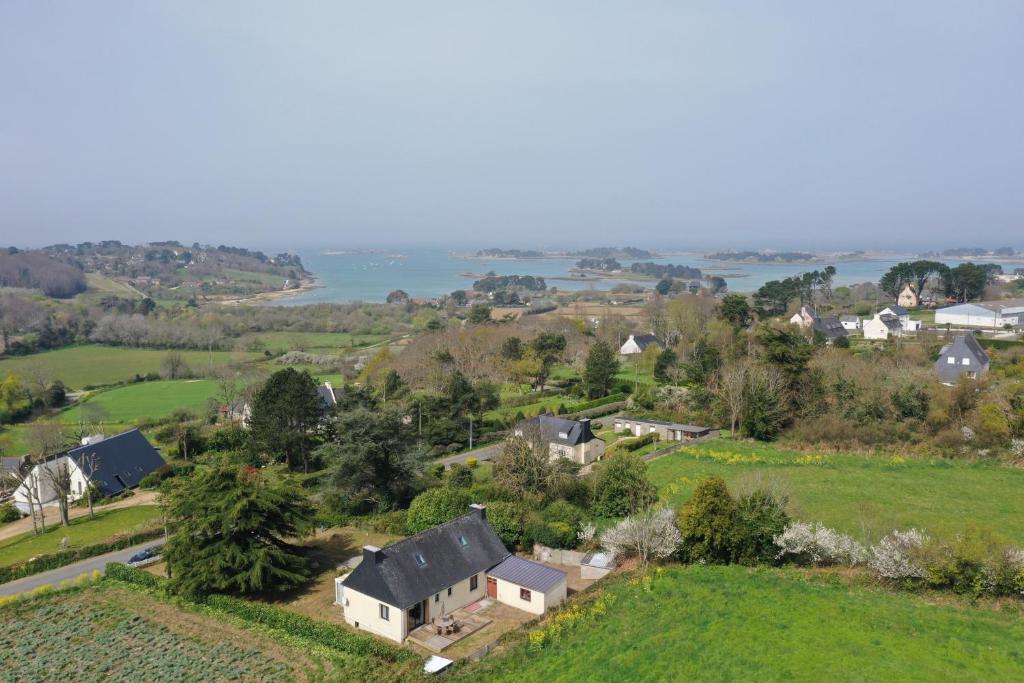 an aerial view of a house on a hill at la maison du bord de mer in Penvénan