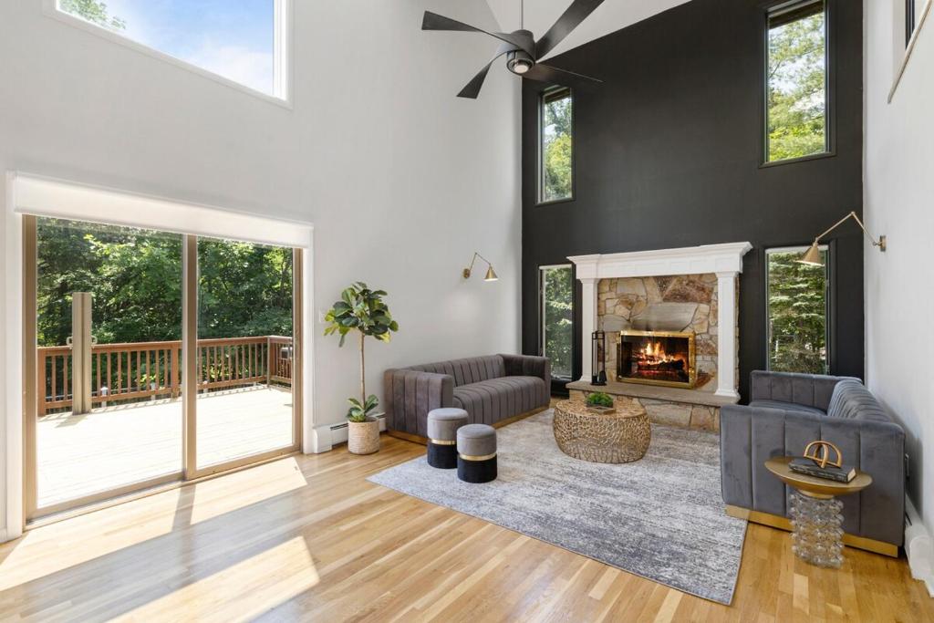 Una sala de estar con un sofá y una chimenea. en Upper Saddle River Resort w Pool, Hot Tub & Lake, en Airmont