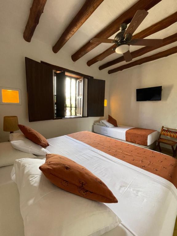 Postel nebo postele na pokoji v ubytování Hotel Hicasua y Centro de Convenciones