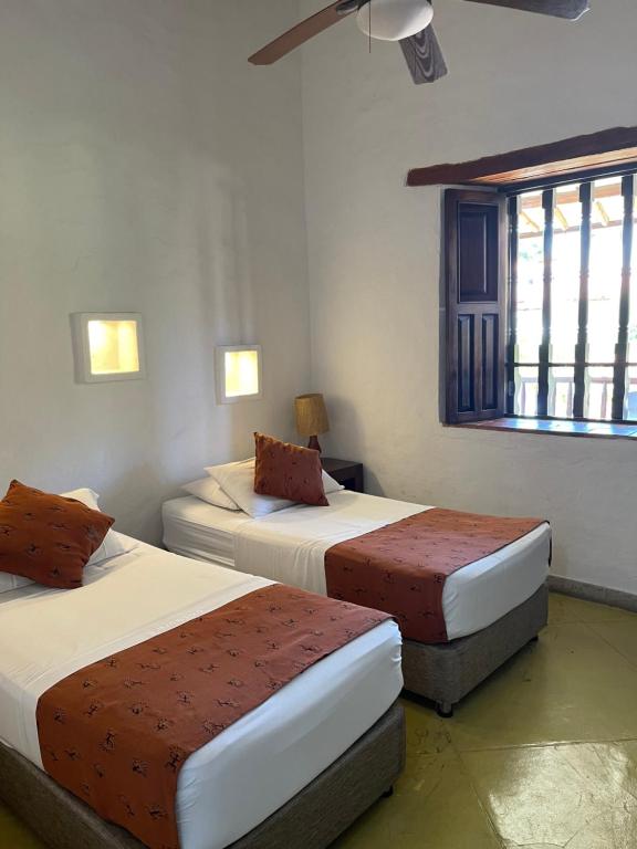 Postel nebo postele na pokoji v ubytování Hotel Hicasua y Centro de Convenciones