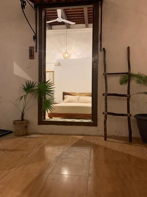 a bedroom with a mirror and a bed in a room at Villa Mediterranea in Campeche