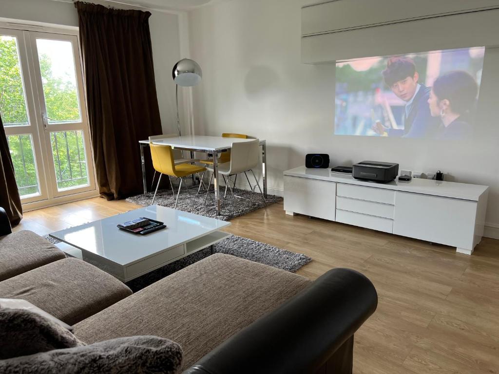 a living room with a couch and a table at The Premier Living Experience Entire 2-Bedroom Modern Apartment in Bromley