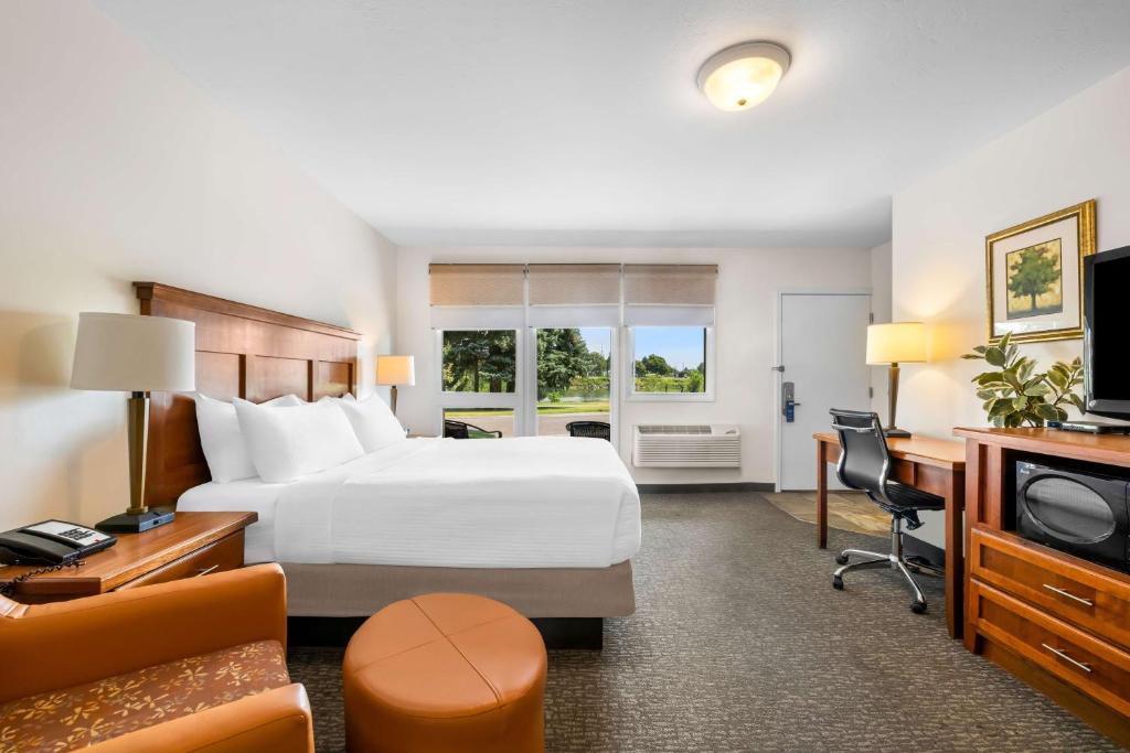 a hotel room with a bed and a desk at Best Western Driftwood Inn in Idaho Falls