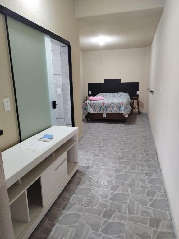 a bathroom with a large mirror and a bed at Casa de Praia Família Próximo ao ExpoCentro BC in Balneário Camboriú