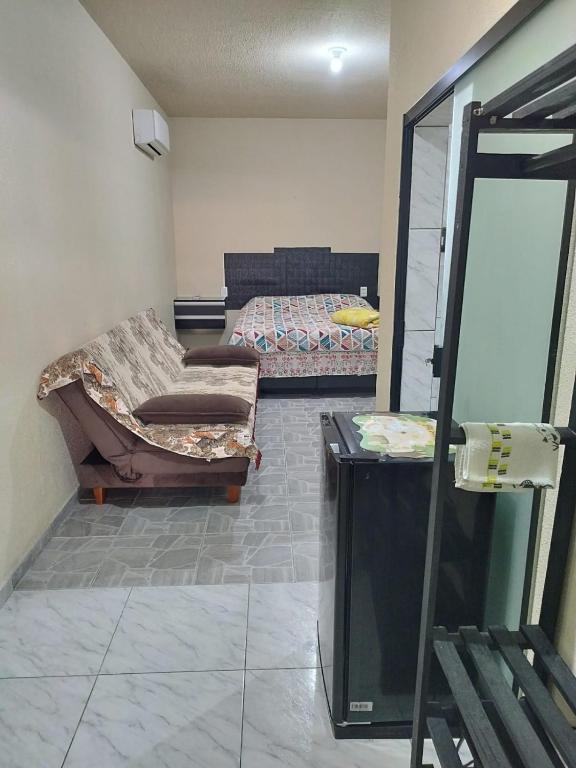 a living room with two beds and a tv at Casa de Praia Família Próximo ao ExpoCentro BC in Balneário Camboriú