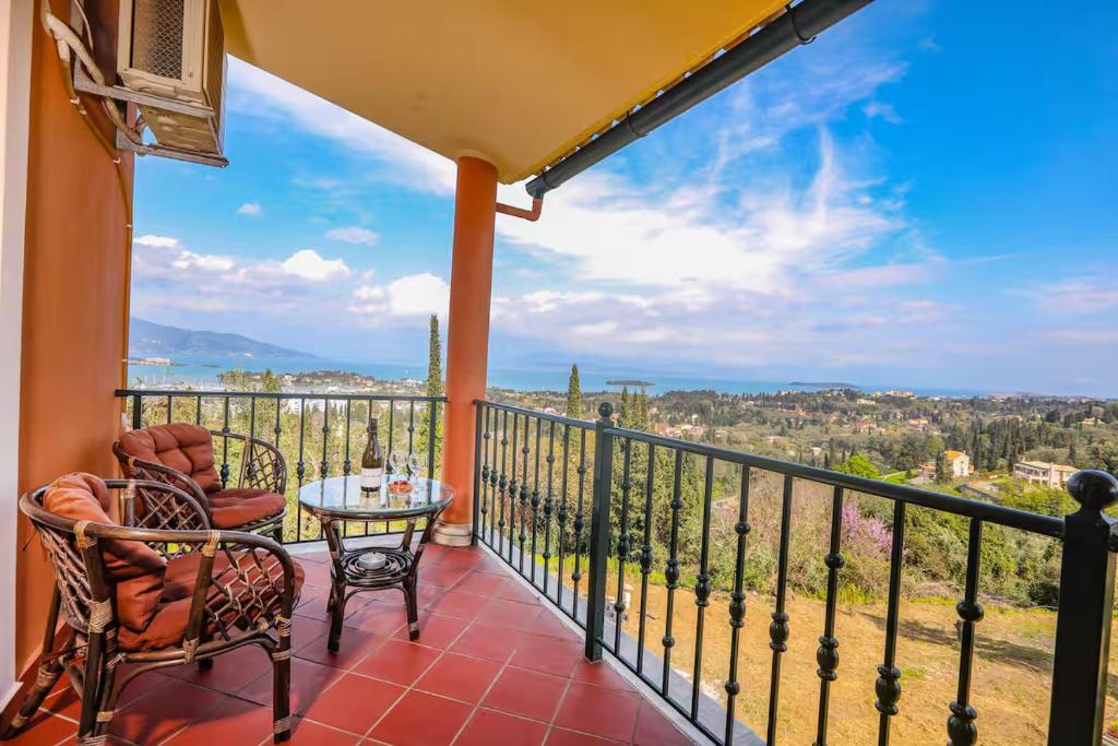 a balcony with a table and chairs and a view at Maison See View in Kontokali