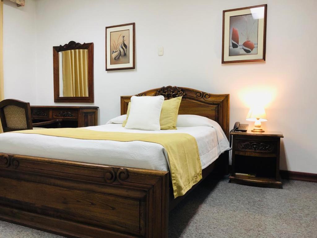 Postel nebo postele na pokoji v ubytování El Gran Hotel de Pereira