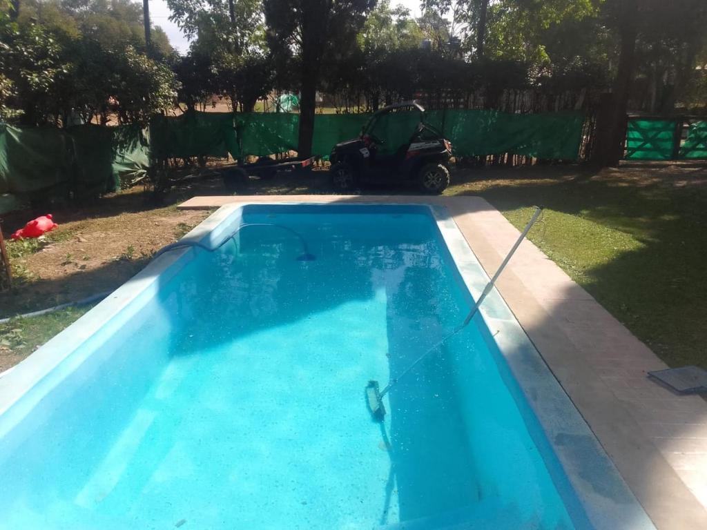 a swimming pool in a yard with a moped at Arroyo seco playa hermosa in Arroyo Seco