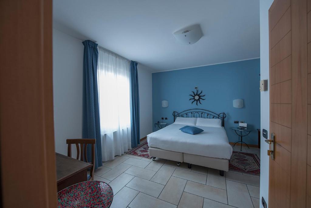 Posteľ alebo postele v izbe v ubytovaní Hotel Villa Colico