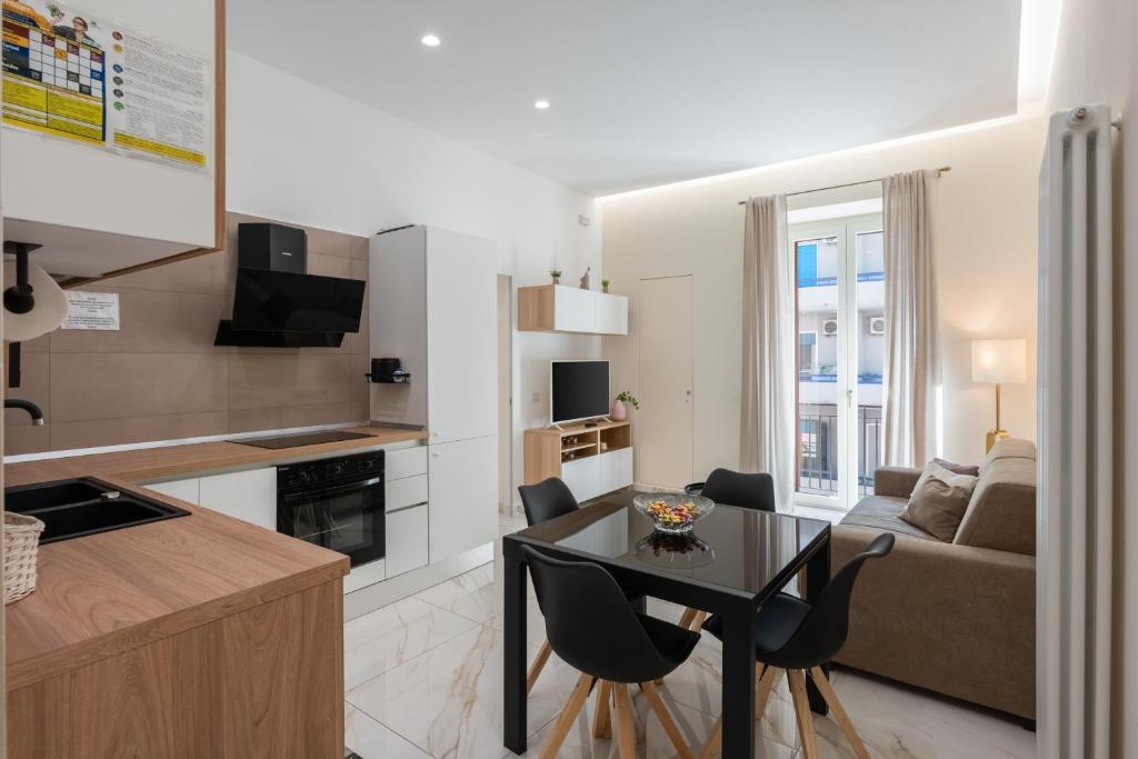 a kitchen and living room with a table and chairs at Maison38GuestHouse in Castellammare di Stabia