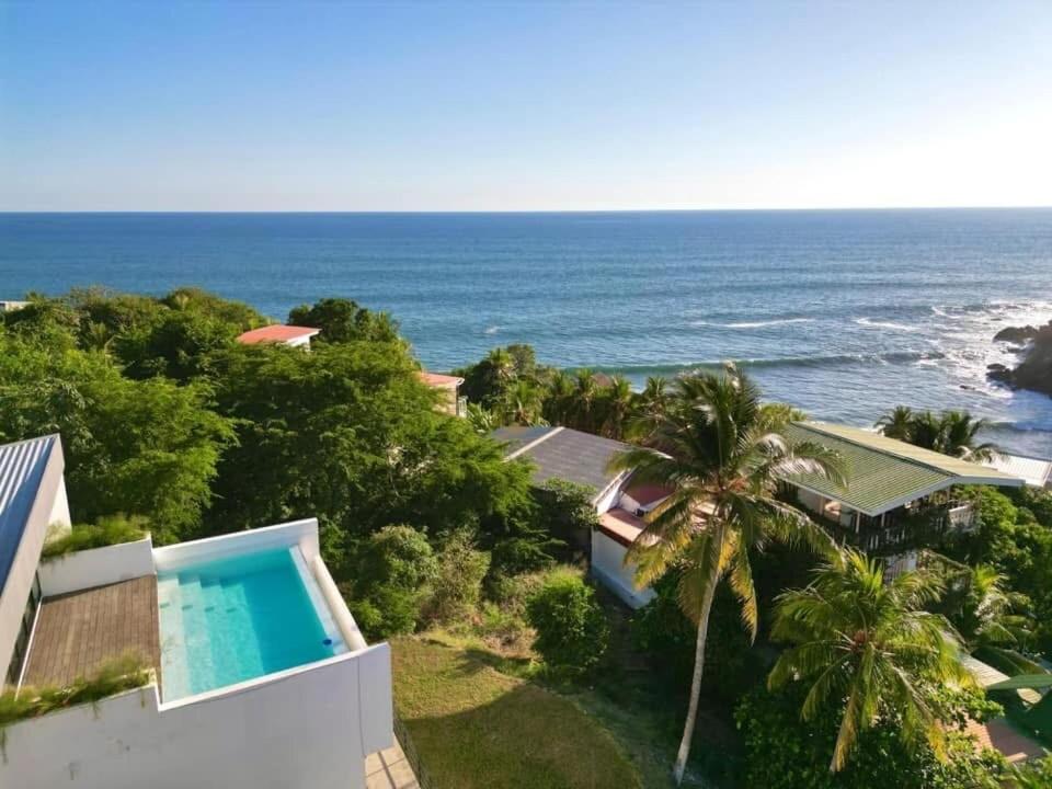 an aerial view of a house and the ocean at St Michaels Ocean View House in El Zonte