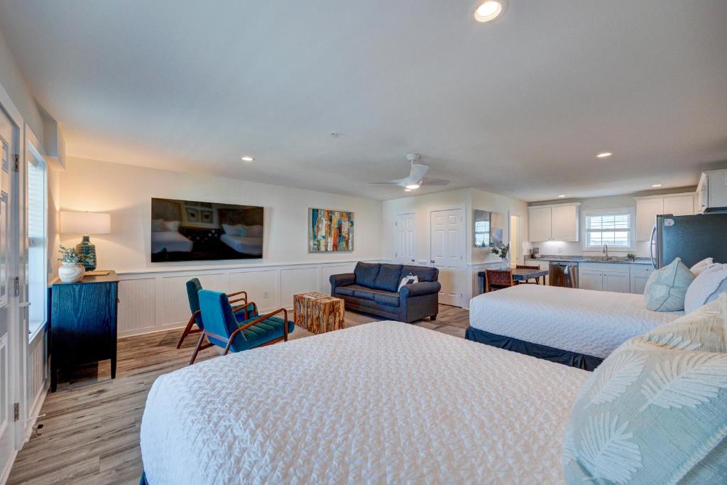 a bedroom with two beds and a living room at 304 Queen Suite, 3rd Floor Nest in Surf City