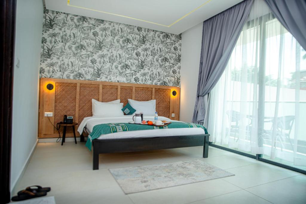 Postel nebo postele na pokoji v ubytování Hotel Yatchenin Abidjan