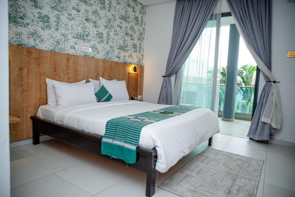 Postel nebo postele na pokoji v ubytování Hotel Yatchenin Abidjan