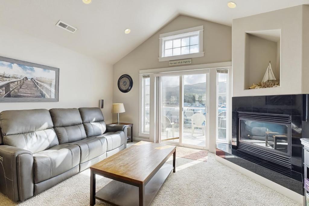a living room with a couch and a fireplace at A Place away from the Pace in Rockaway Beach