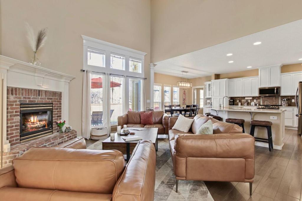a living room with leather furniture and a fireplace at Eagles Landing Spacious Family Getaway w Office in Eagle