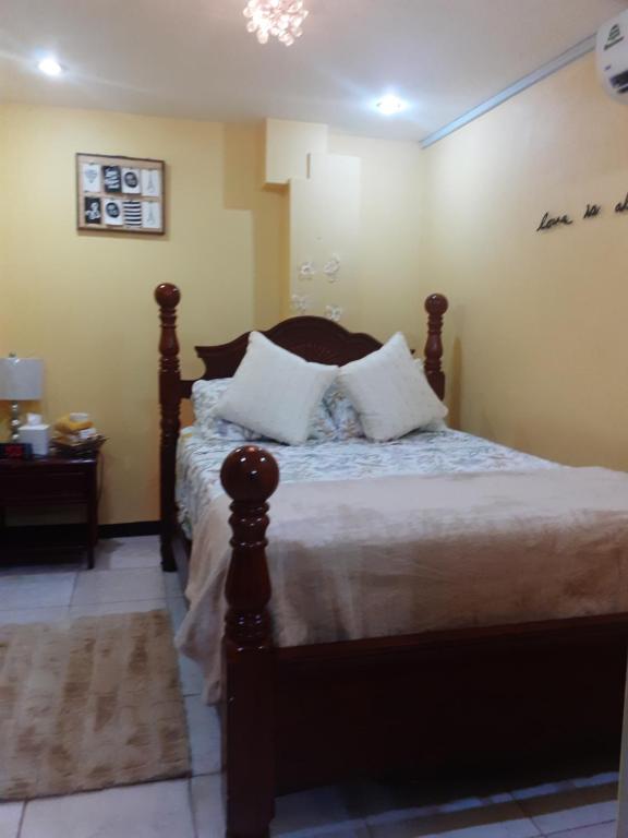 a bedroom with a bed with white pillows on it at Essentials Suite in Bon Accord