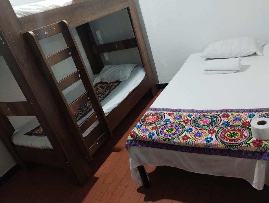 a bedroom with two bunk beds and a mirror at Casa Turistica Valeriana in Cali