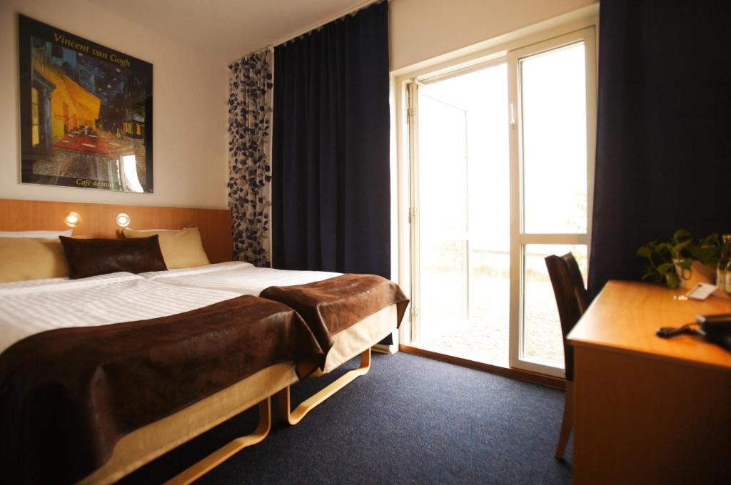 Postel nebo postele na pokoji v ubytování Hotell Höga Kusten