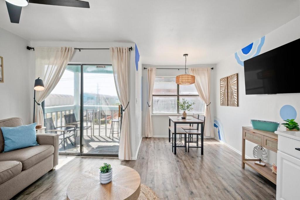 a living room with a couch and a table at Vitamin Sea in Gulf Shores