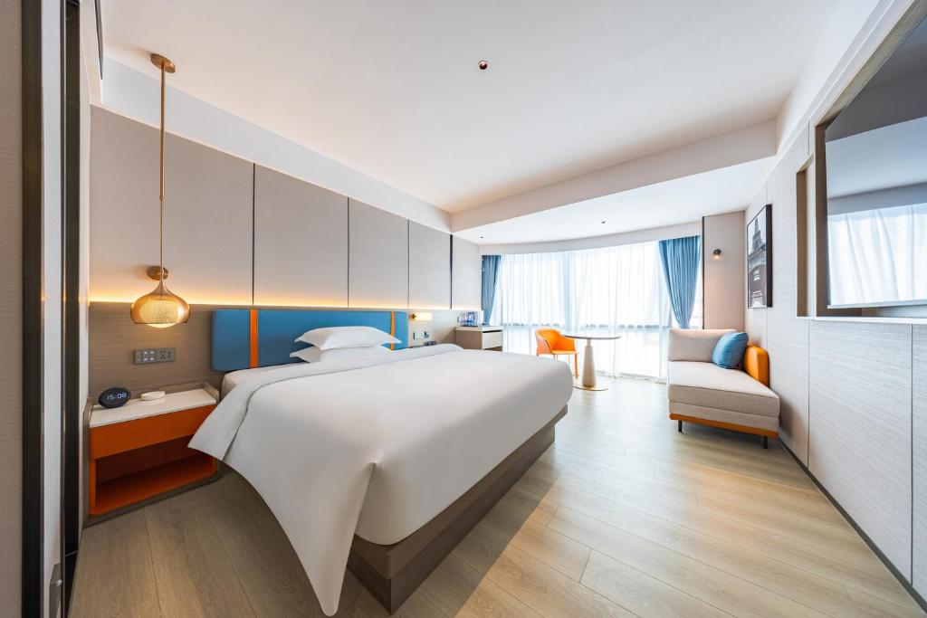 Postel nebo postele na pokoji v ubytování 颐程City View Hotel-广州太古汇珠江新城体育中心石牌桥地铁站店-广交会专享