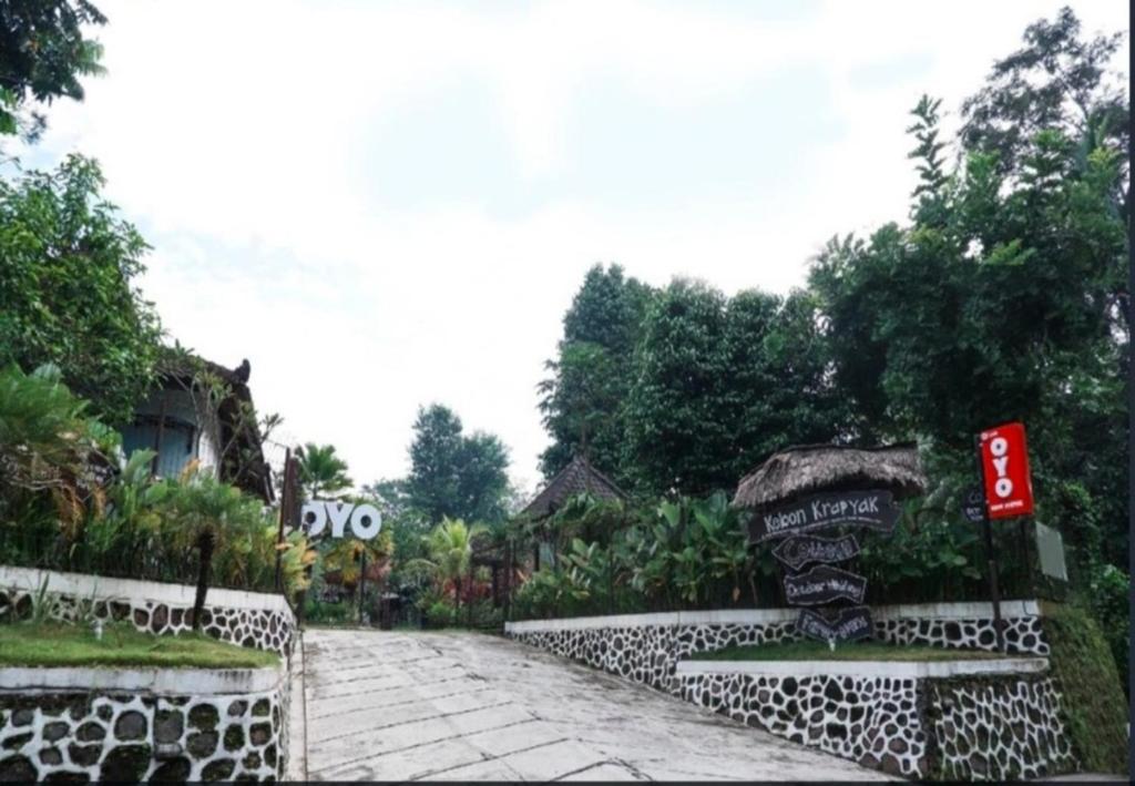 a walkway with a sign on the side of a road at KK by Secoms in Yogyakarta