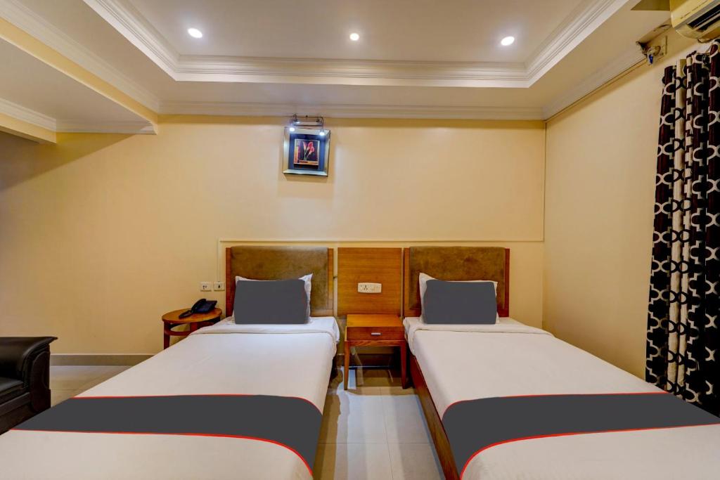 Postel nebo postele na pokoji v ubytování Super Hotel O G Silver Ashok Nagar