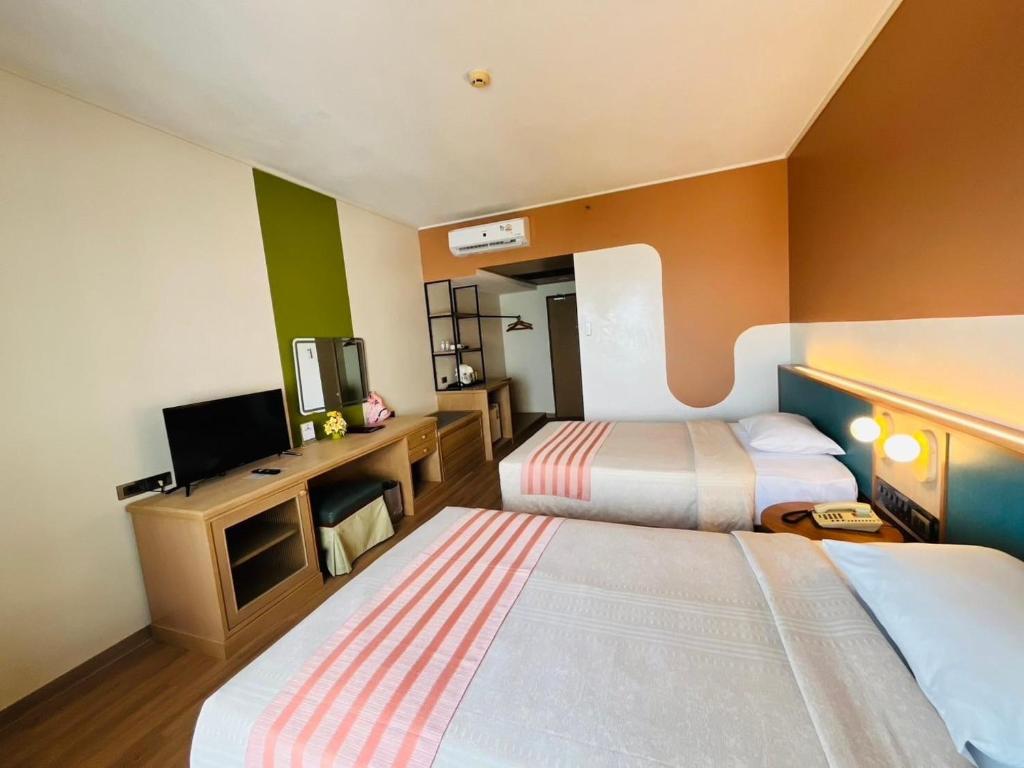 Postel nebo postele na pokoji v ubytování Asia Cha-am Hotel