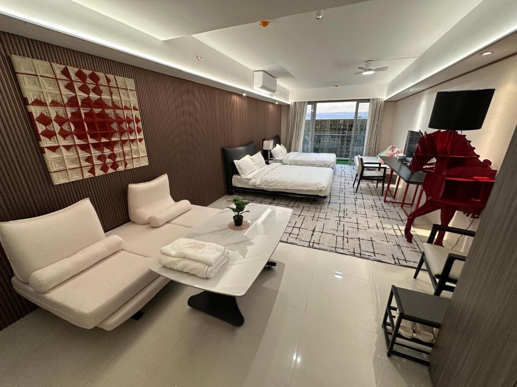 a living room with a white couch and a piano at Luxury Penthouse hotel near City of Dreams Casino1 in Manila