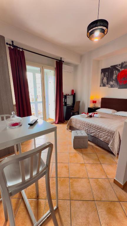 a bedroom with a bed and a table and a desk at B&B Vanvitelli Home in Caserta
