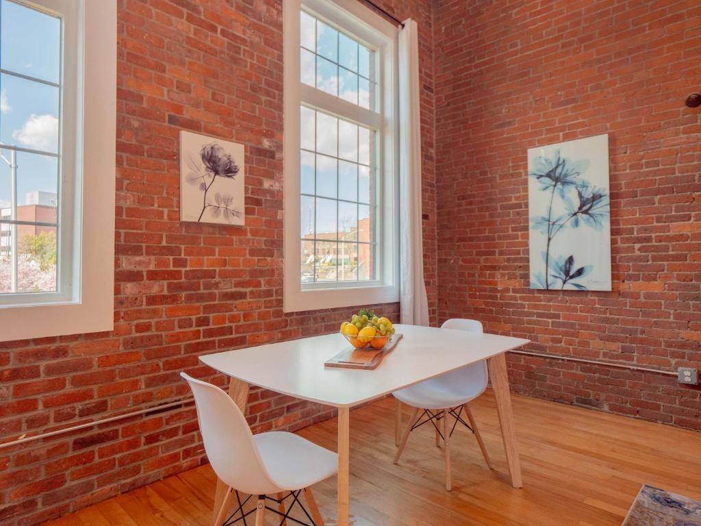 プロビデンスにあるJennifer's Historic Brick Riverfront Loft Apartmentの白いテーブルと椅子