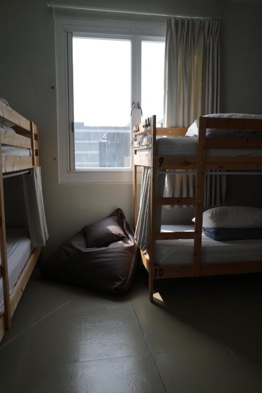 Postel nebo postele na pokoji v ubytování Ji Zi Inn