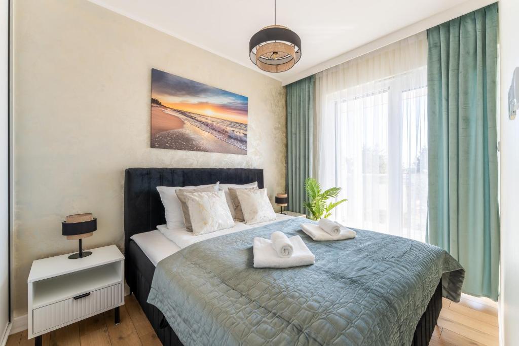 Ένα ή περισσότερα κρεβάτια σε δωμάτιο στο Apartament 208 - by Perłowa Przystań Rent