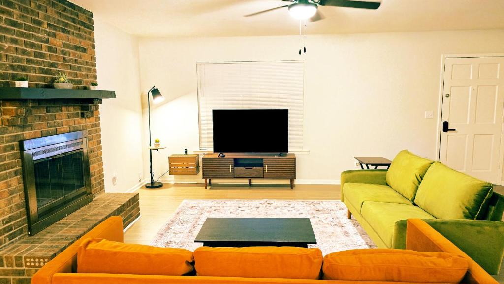 a living room with a couch and a fireplace at Comfort By the Bay Close to Mobile International Airport in Mobile