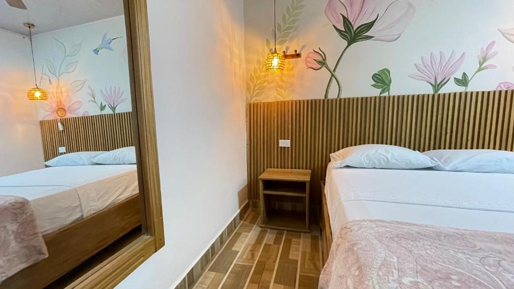 Postel nebo postele na pokoji v ubytování Hotel BJ Curumani