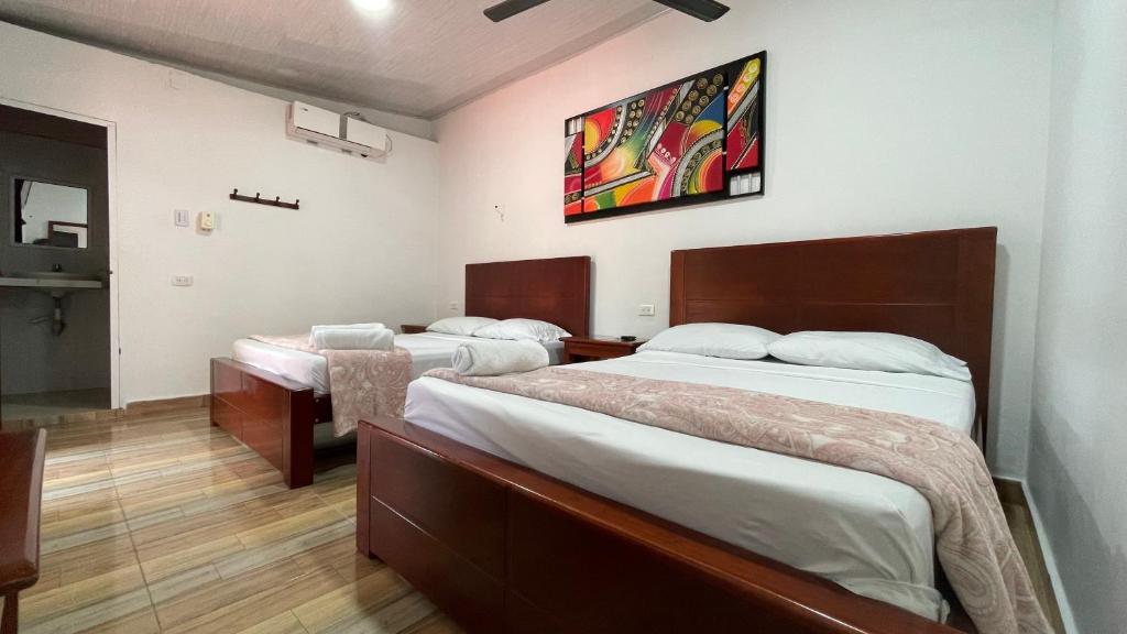 Postel nebo postele na pokoji v ubytování Hotel BJ Curumani