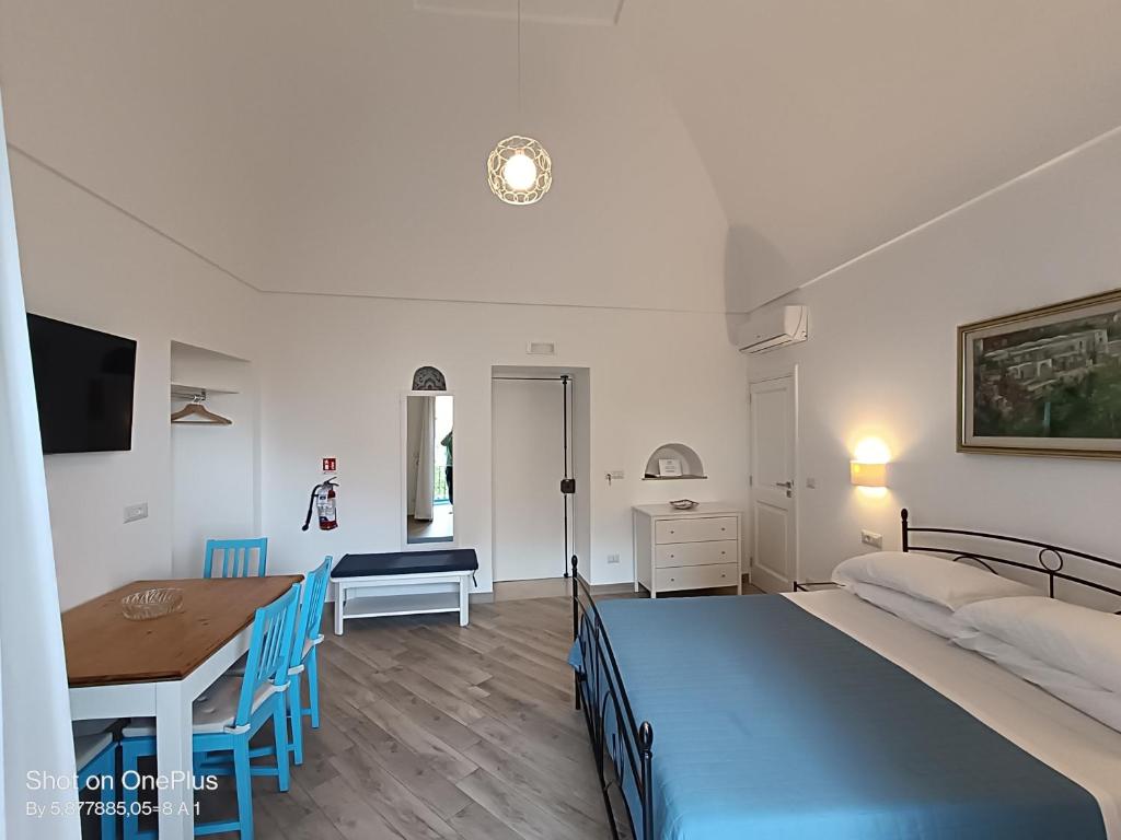 a bedroom with a bed and a table and a desk at Regina Margherita in Positano