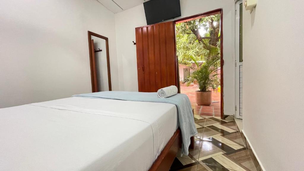 Postel nebo postele na pokoji v ubytování Hotel BJ Curumani