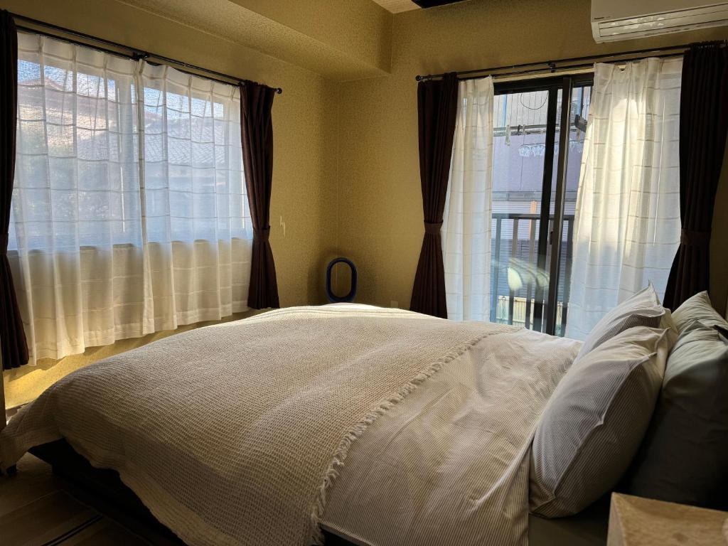 Postel nebo postele na pokoji v ubytování 五斗觀驛站 gotokan guest house