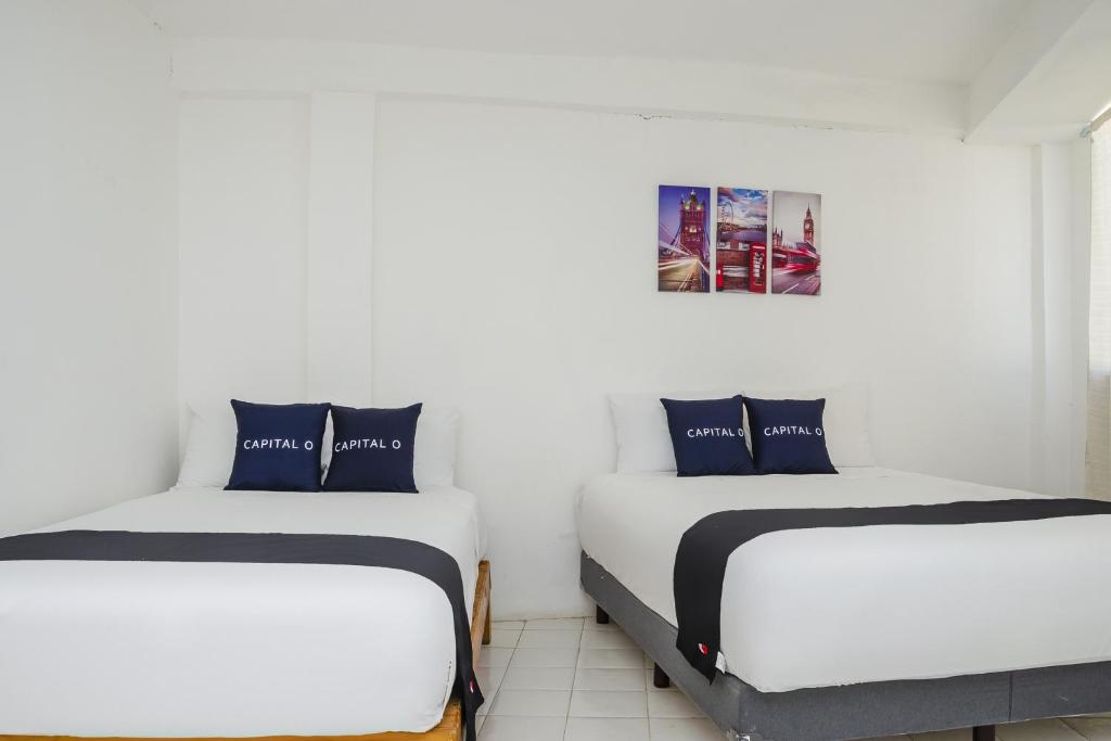 Postel nebo postele na pokoji v ubytování Capital O Hotel Dos Mares, Cabo San Lucas