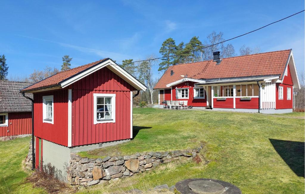 a red and white house with a yard at Nice Home In Vittsjö With Sauna in Vittsjö
