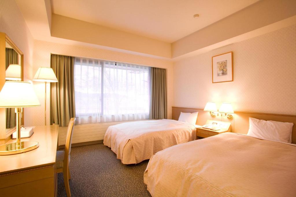 Postel nebo postele na pokoji v ubytování Izumigo AMBIENT Tateshina Hotel