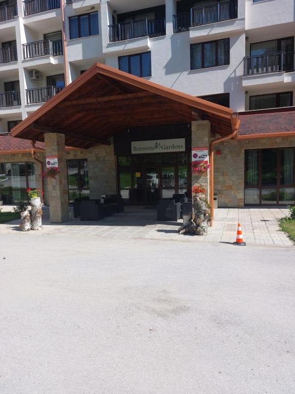 a building in front of a large building at ТЕС Боровец Гарденс in Borovets