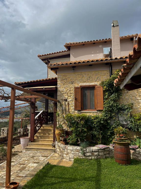 a house with a staircase leading to a window at Villa Eva's in Himare