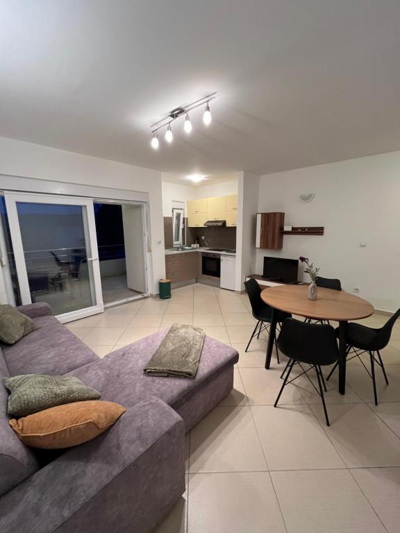 a living room with a couch and a table at Apartments Maria & Marta in Seline