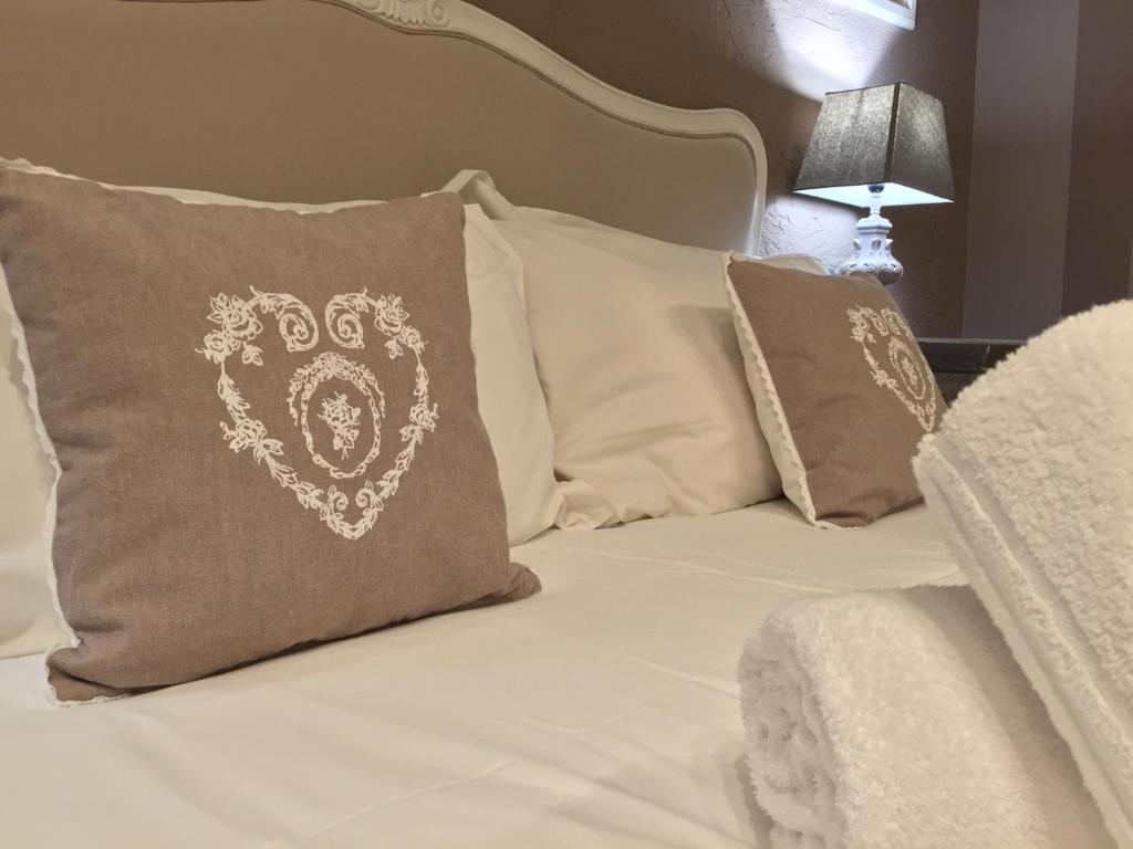 a bed with a pillow with a dog on it at 29 Venti Luxury in Palermo