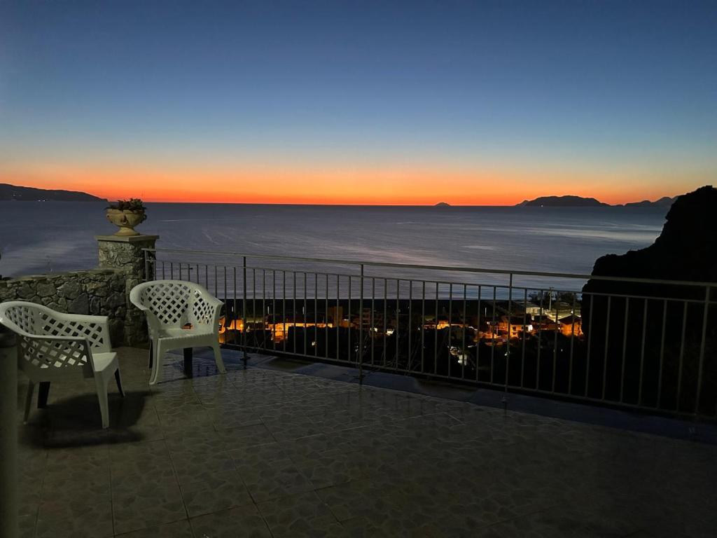 two chairs on a balcony with a view of the ocean at CASA TALIA in Milazzo