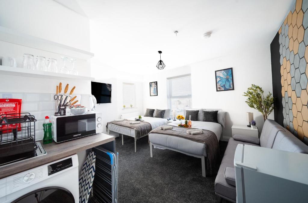 a living room with two couches and a tv at Open Mind Property - Flat with 2 Double Beds in Bognor Regis