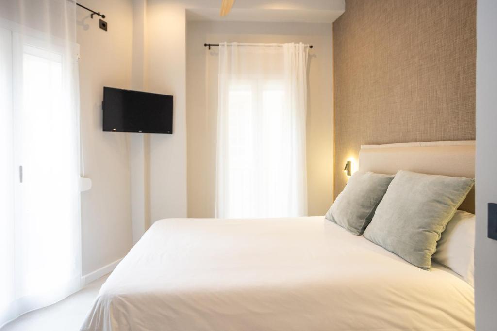 Posteľ alebo postele v izbe v ubytovaní Chinitas Urban Rooms